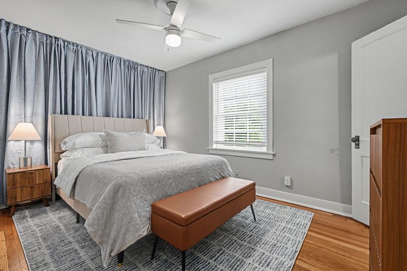 Bedroom in Apartment 3N with queen bed and full curtain wall